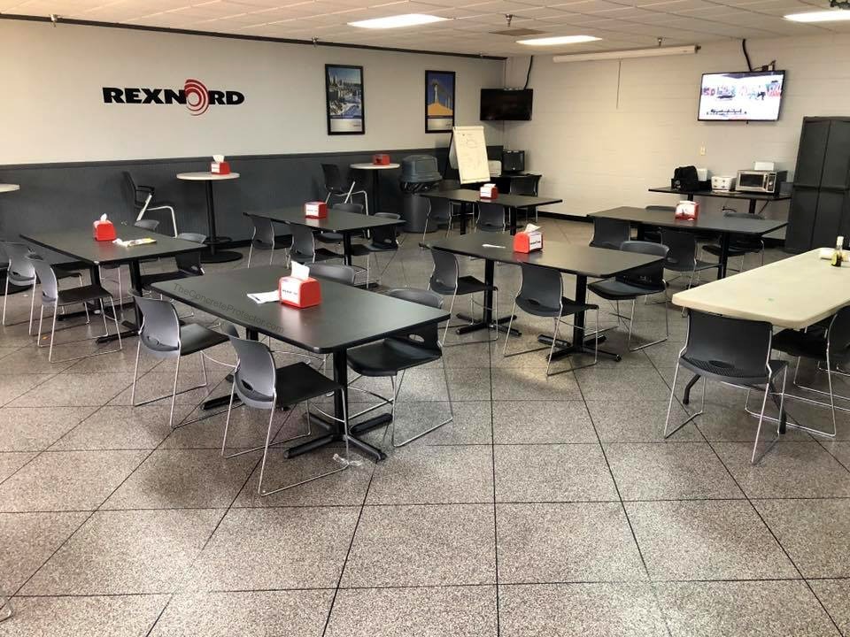 Epoxy tile flooring in a commercial breakroom — large format gray tile pattern with clean grout lines over concrete