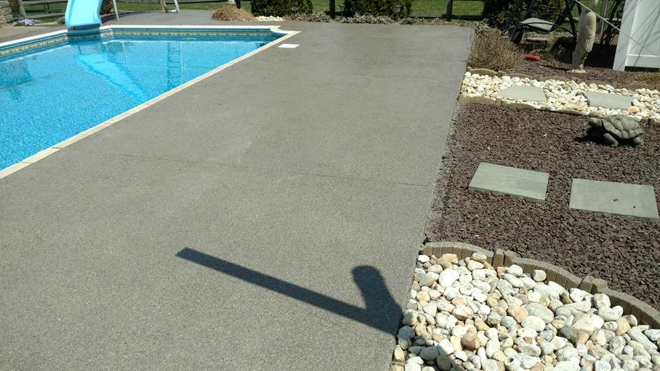 Granitflex concrete coating on a residential pool deck — gray aggregate blend with slip-resistant texture