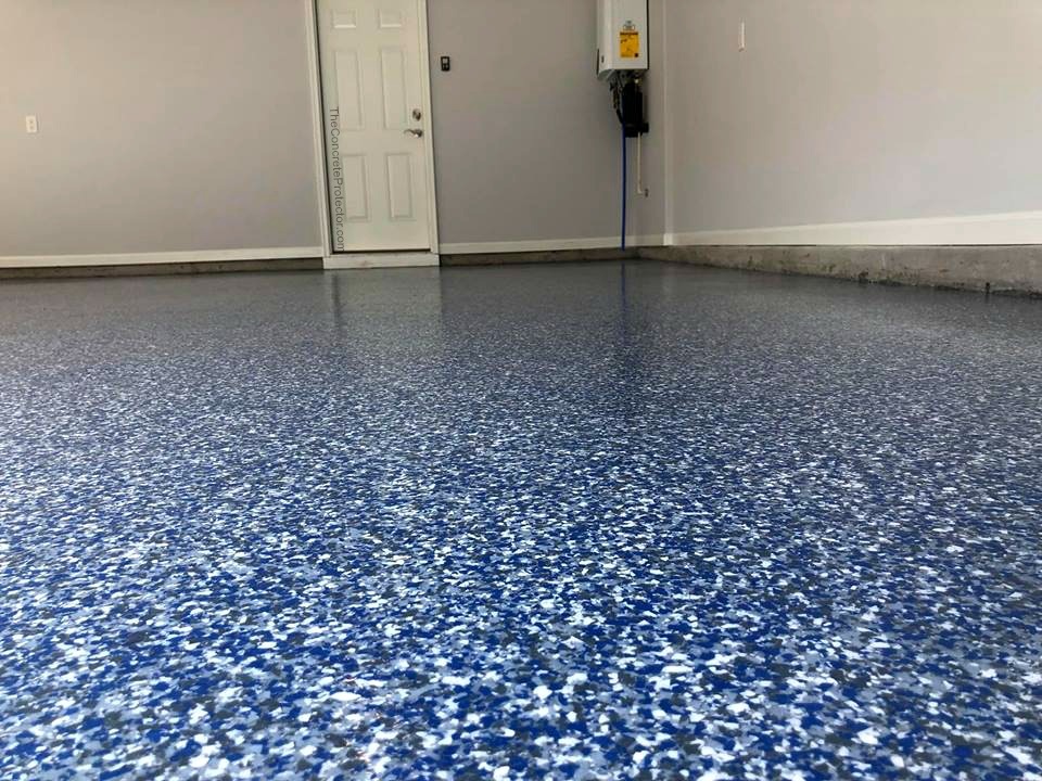 Epoxy color flake garage floor coating — blue and white full-rejection flake broadcast with polyaspartic top coat