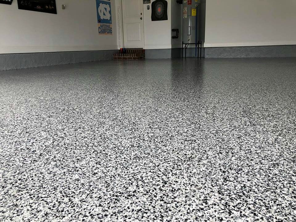 Epoxy color flake garage floor — gray, black, and white flake blend covering a full two-car garage